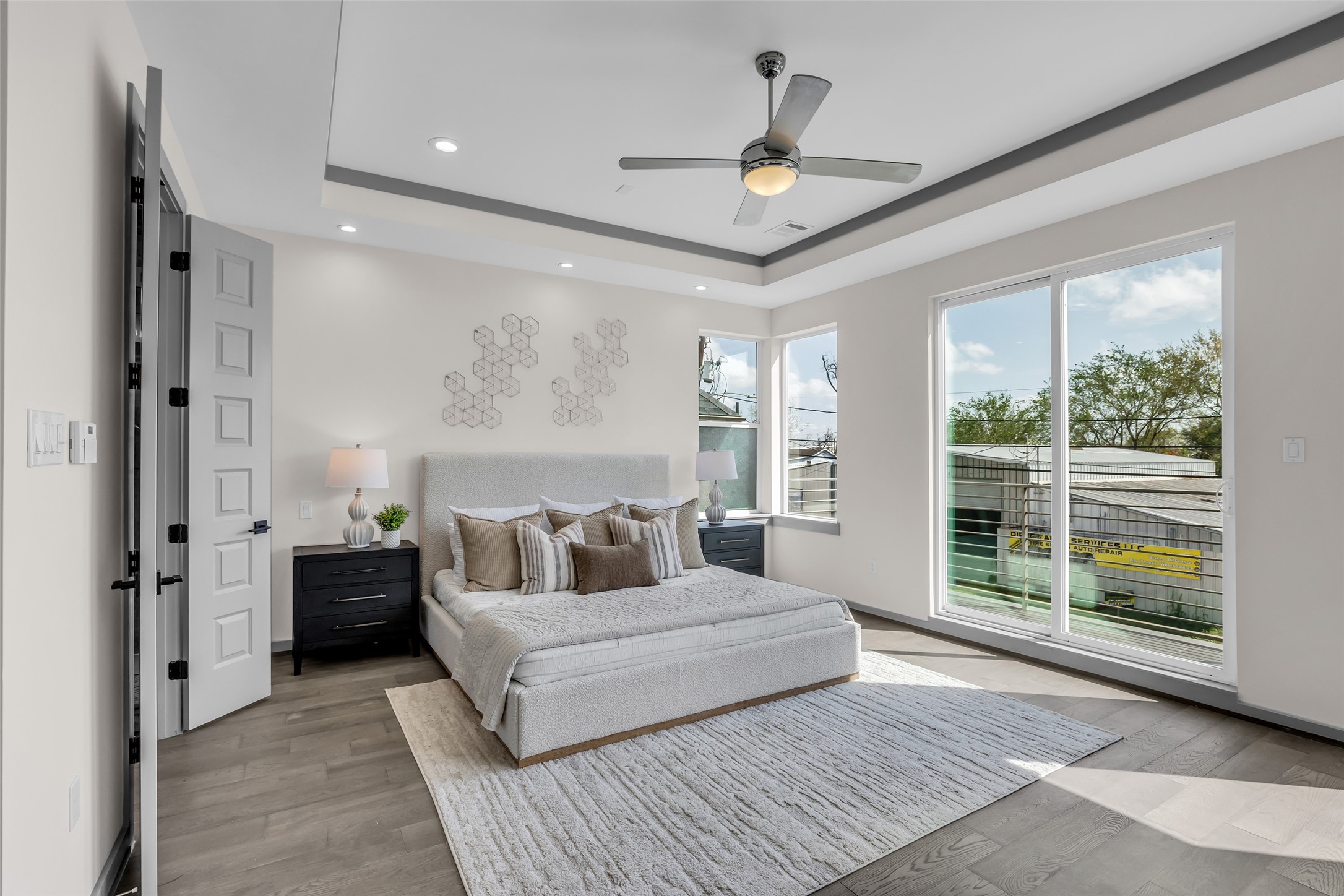 1207 East 28th Street Houston, TX 77009 - Photo 20 of 38 a spacious bedroom with a large bed and a chandelier