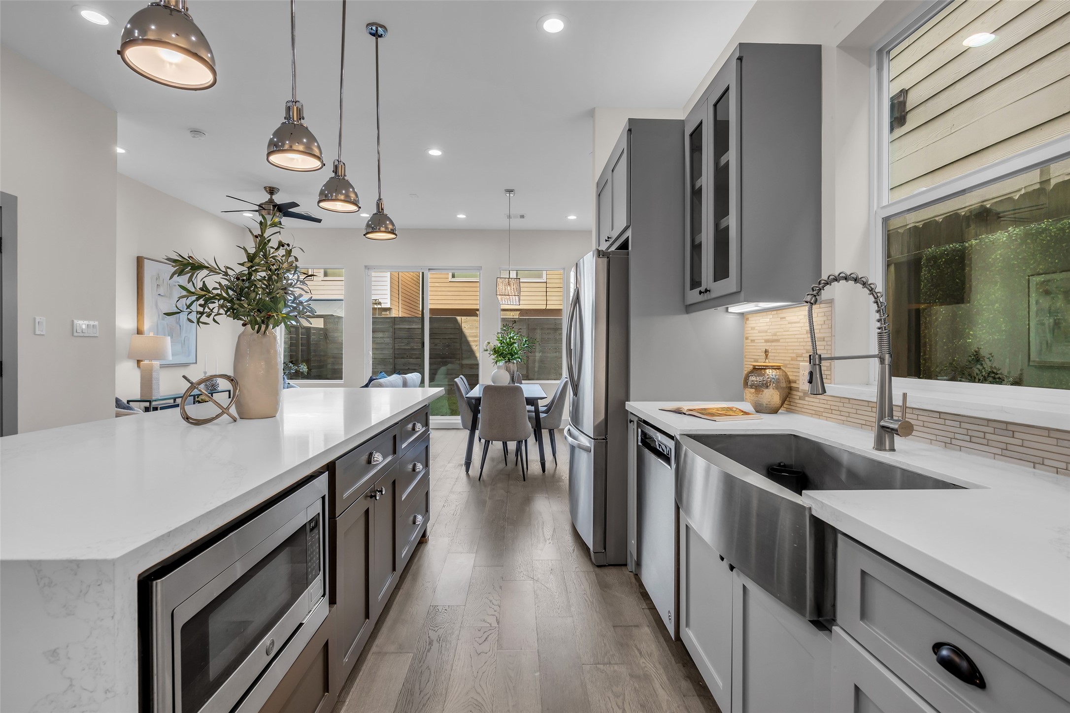 1207 East 28th Street Houston, TX 77009 - Photo 6 of 38 a kitchen with kitchen island granite countertop a sink a counter space and stainless steel appliances