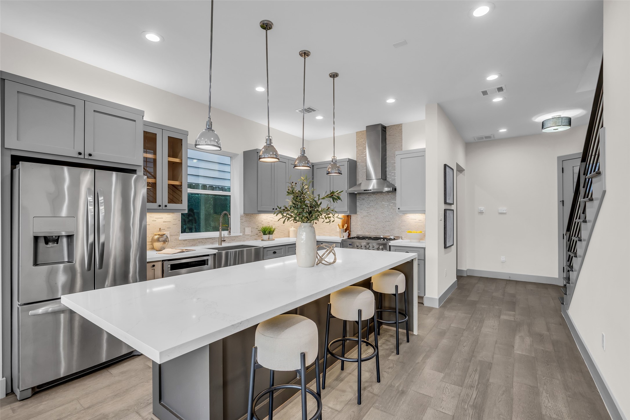 1207 East 28th Street Houston, TX 77009 - Photo 8 of 38 a kitchen with stainless steel appliances refrigerator dining table and chairs