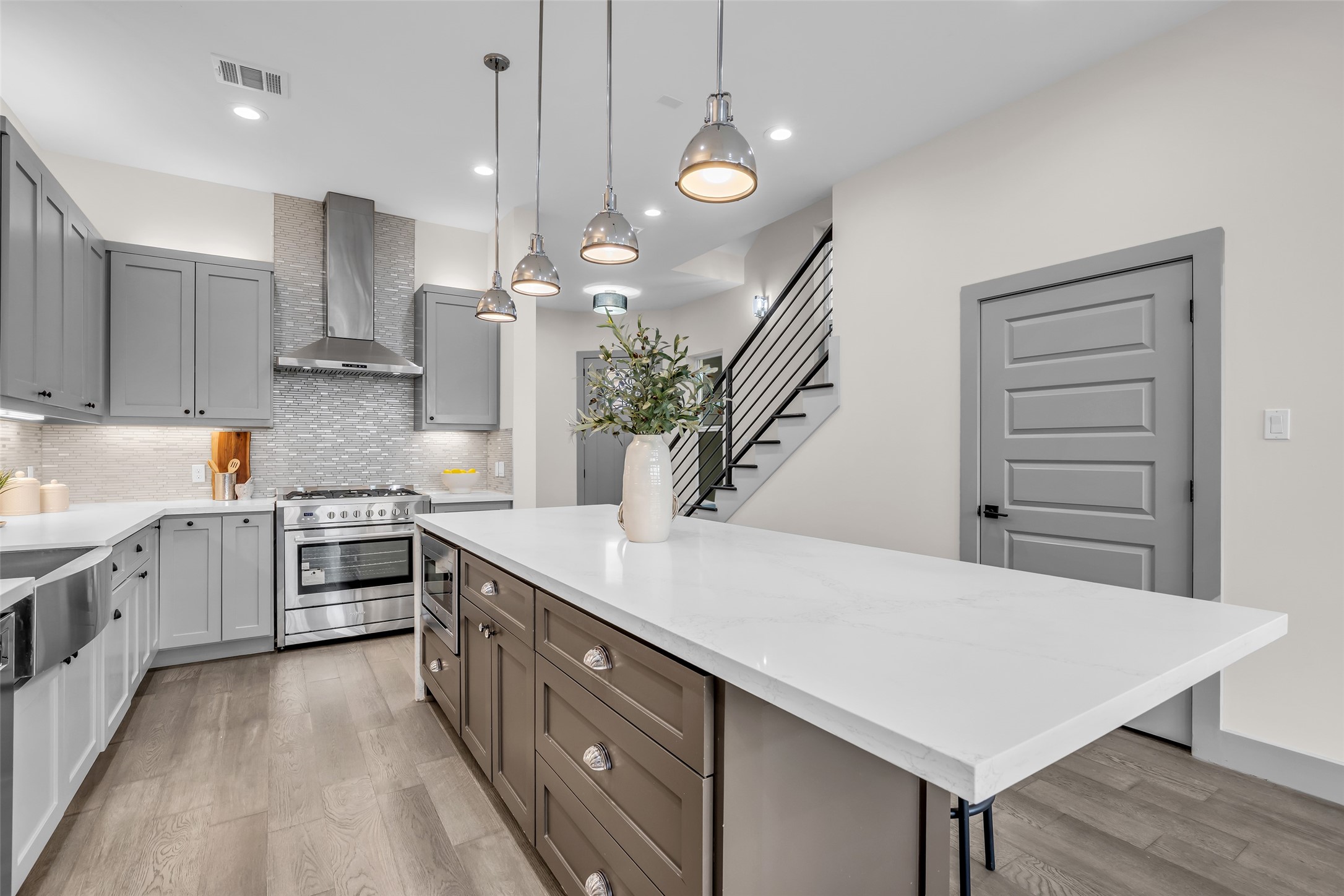 1207 East 28th Street Houston, TX 77009 - Photo 10 of 38 a kitchen with white cabinets and stainless steel appliances