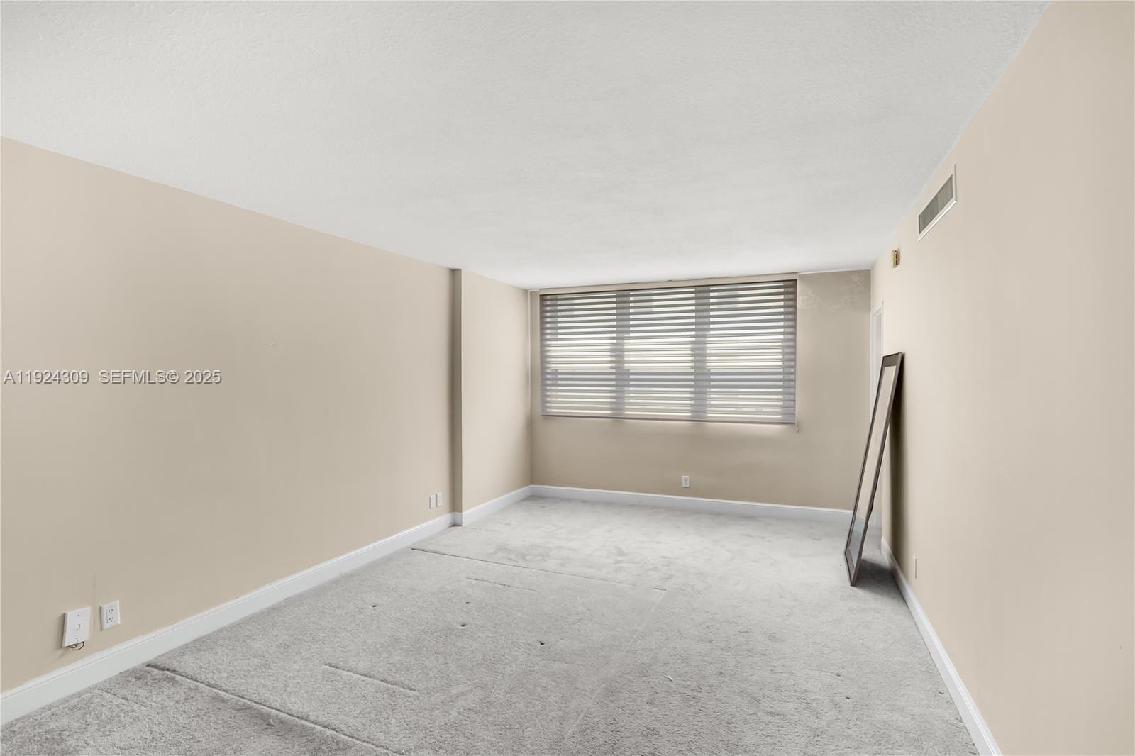 9225 Collins Avenue, Unit 612 Surfside, FL 33154 - Photo 11 of 38 a view of an empty room with a window