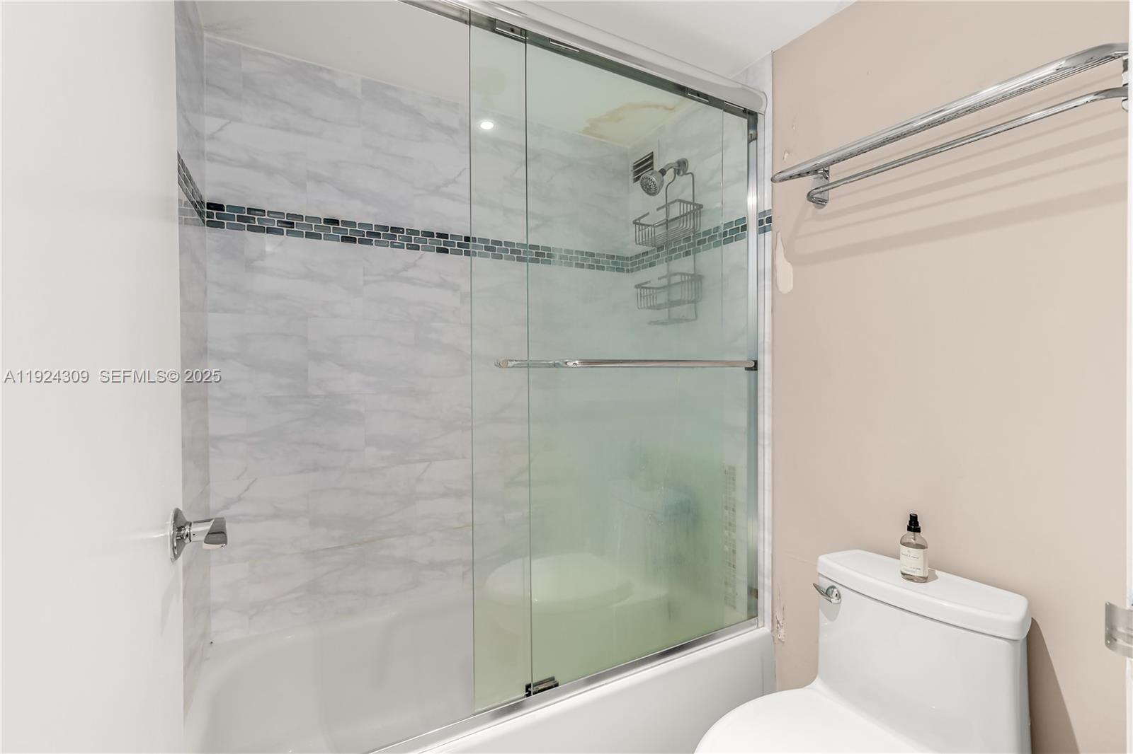 9225 Collins Avenue, Unit 612 Surfside, FL 33154 - Photo 14 of 38 a bathroom with a shower a toilet and a shower