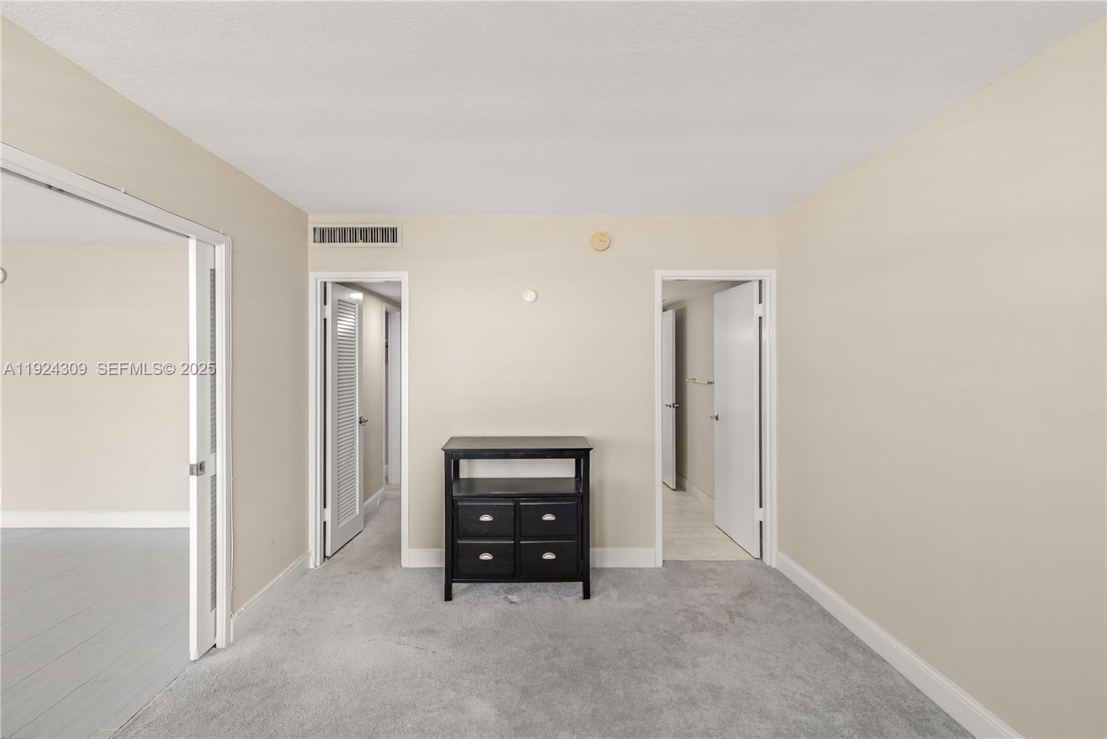 9225 Collins Avenue, Unit 612 Surfside, FL 33154 - Photo 16 of 38 an empty room with windows and cabinet