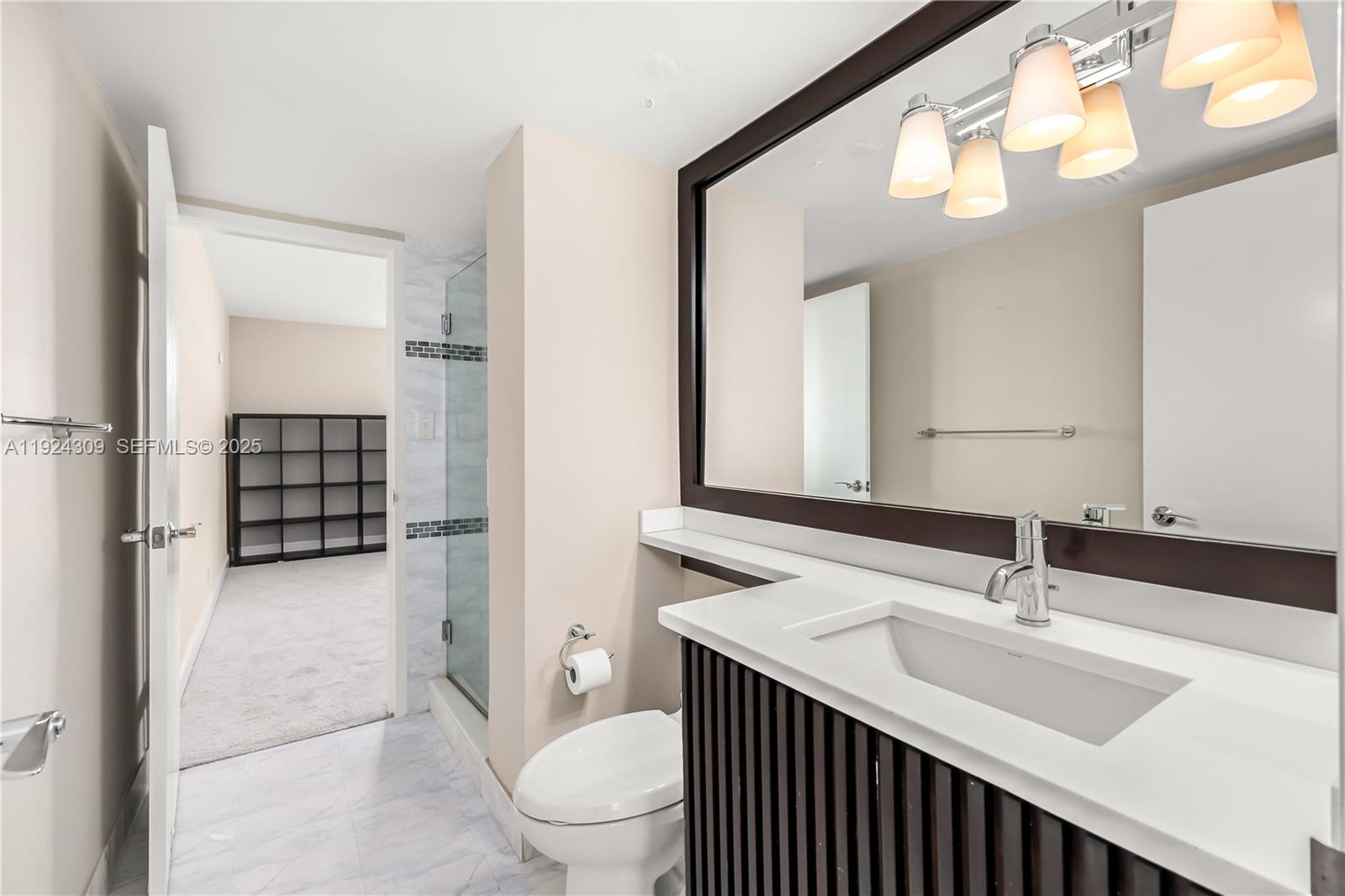 9225 Collins Avenue, Unit 612 Surfside, FL 33154 - Photo 18 of 38 a bathroom with a sink and a toilet