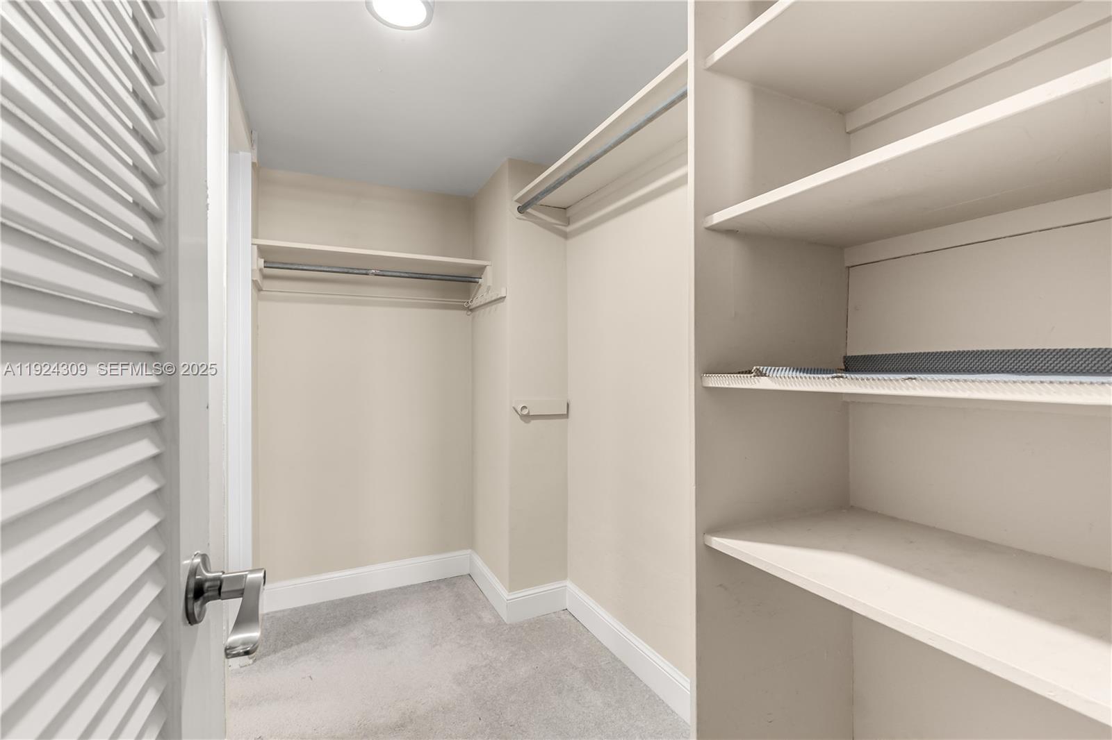 9225 Collins Avenue, Unit 612 Surfside, FL 33154 - Photo 21 of 38 a view of an empty walk in closet