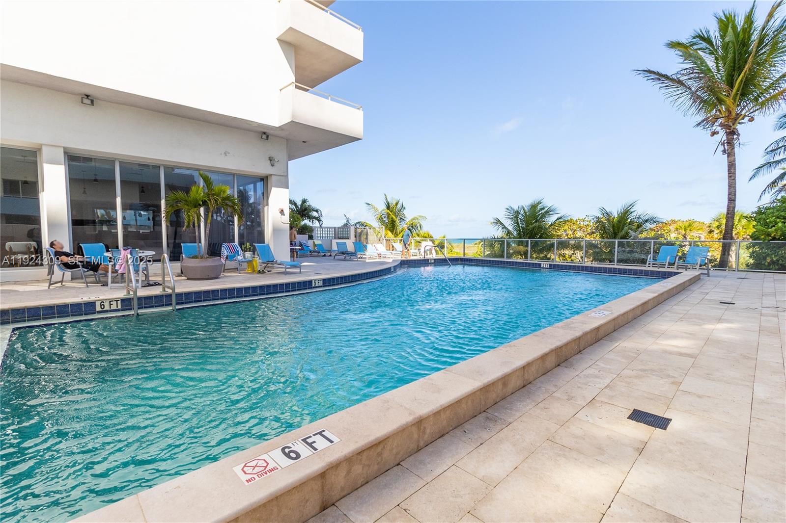 9225 Collins Avenue, Unit 612 Surfside, FL 33154 - Photo 26 of 38 a view of a swimming pool with a lounge chairs