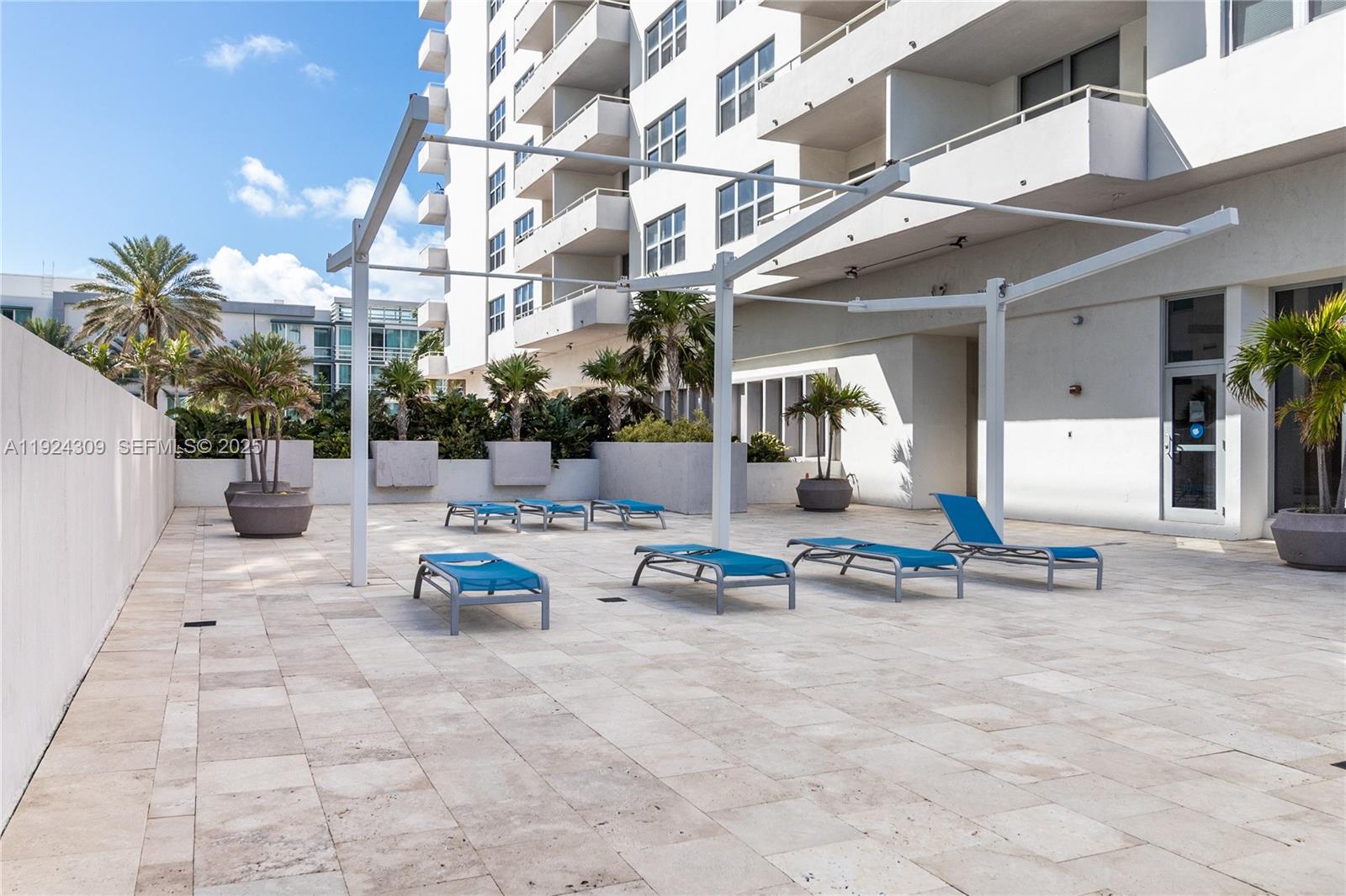 9225 Collins Avenue, Unit 612 Surfside, FL 33154 - Photo 27 of 38 a outdoor space with lots of white furniture