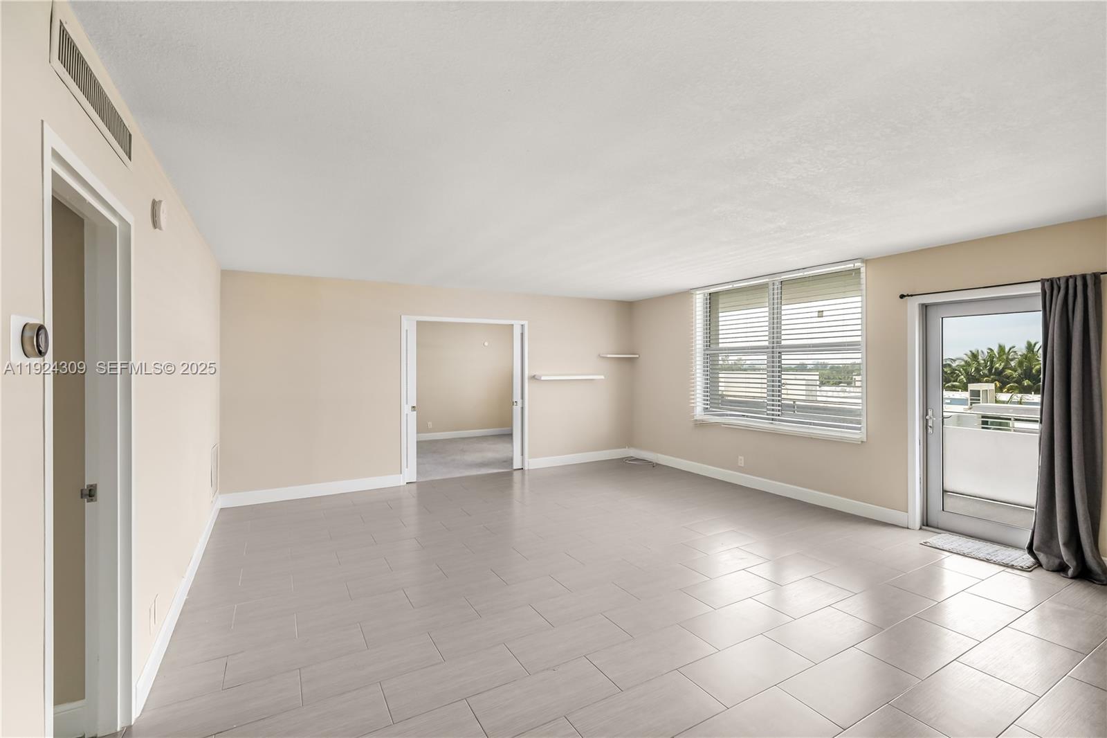 9225 Collins Avenue, Unit 612 Surfside, FL 33154 - Photo 3 of 38 an empty room with windows and closet