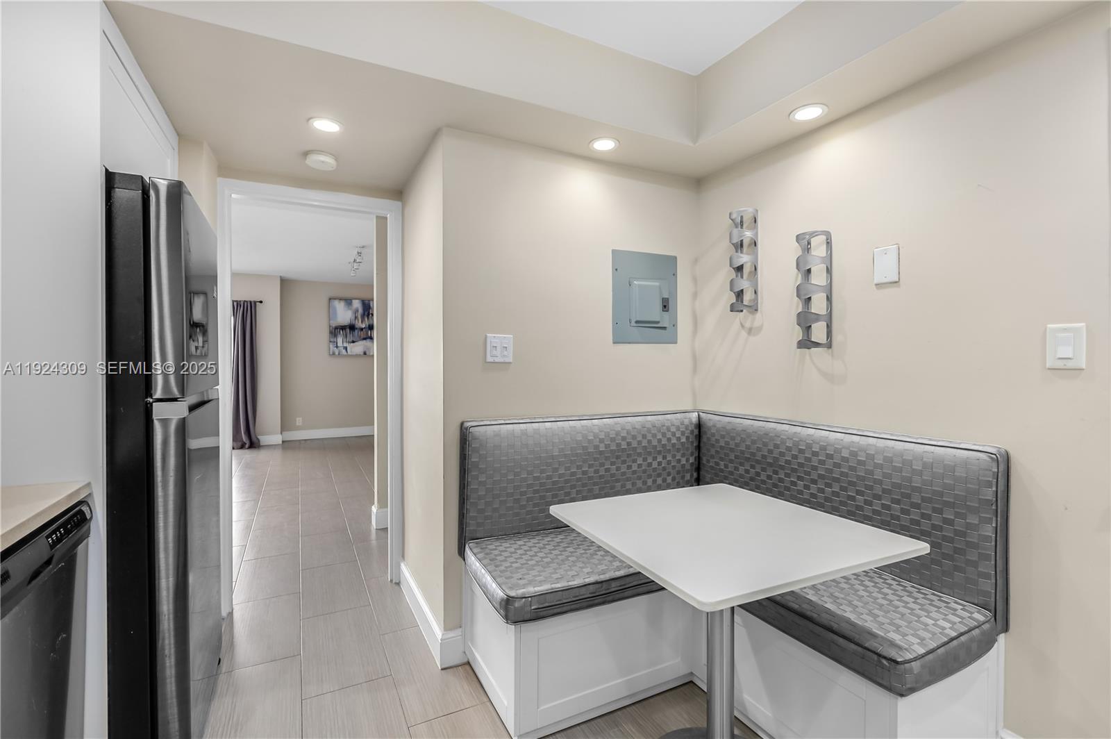 9225 Collins Avenue, Unit 612 Surfside, FL 33154 - Photo 9 of 38 a living room with stainless steel appliances furniture a refrigerator and a kitchen view