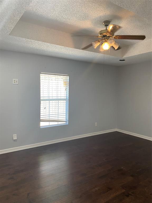 6005 Black Berry Lane Dallas, TX 75248 - Photo 11 of 22 a view of an empty room with wooden floor and a window