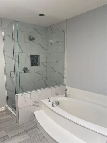 a bathroom with a bathtub and a shower
