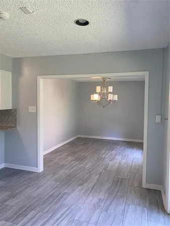 a view of wooden floor and windows in an empty room