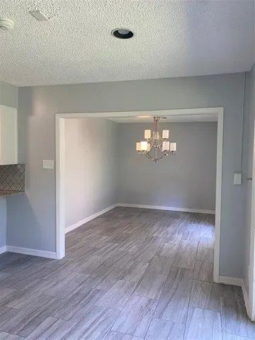 a view of wooden floor and windows in an empty room