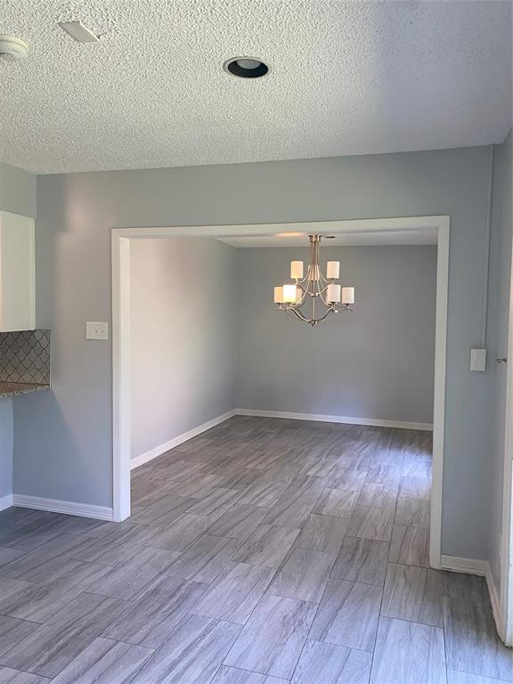 6005 Black Berry Lane Dallas, TX 75248 - Photo 8 of 22 a view of wooden floor and windows in an empty room