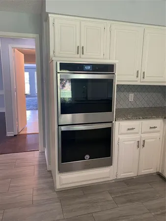 a stove top oven sitting inside of a kitchen