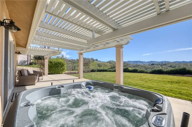 a view of swimming pool with lake view and a floor to ceiling window