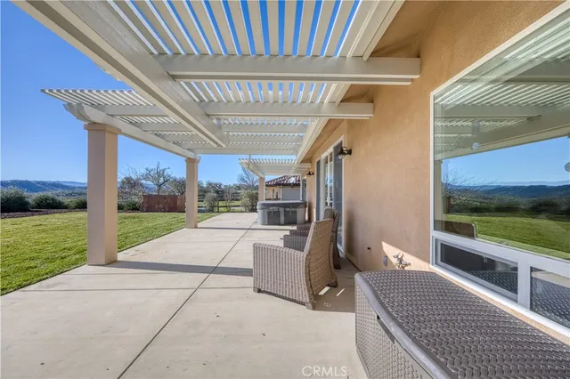 a view of a patio with a table and chairs