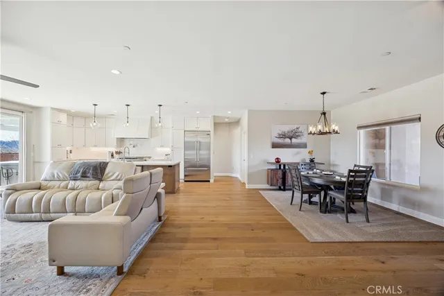 a living room with furniture dining table and a chandelier