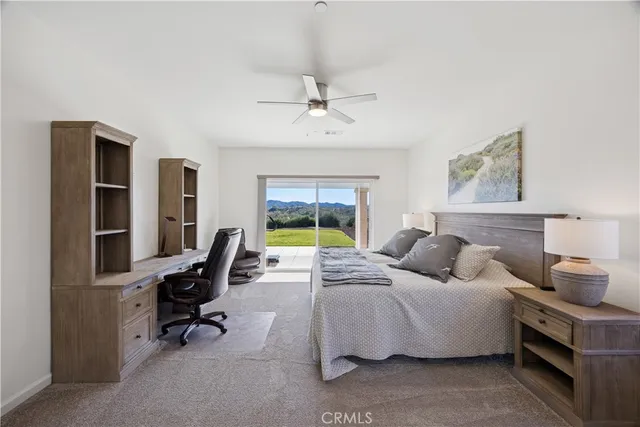 a bedroom with a bed a bookshelf and a chandelier