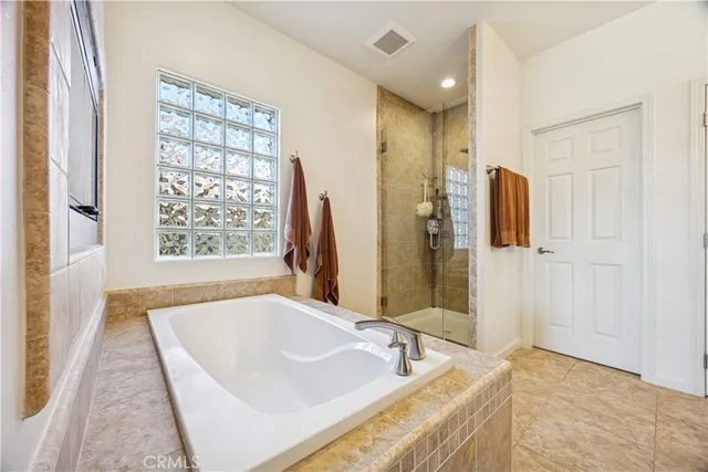 a bathroom with a tub sink and mirror