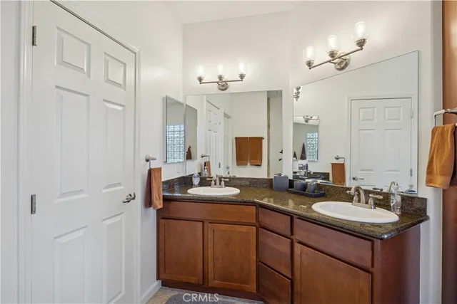 a bathroom with double sink and a mirror