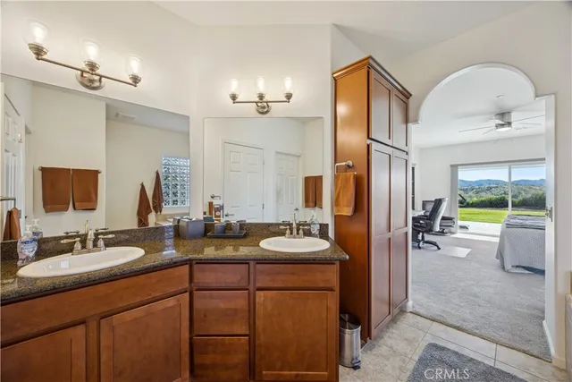 a bathroom with a sink double vanity granite and a mirror