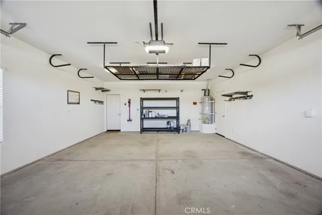 a view of a livingroom with a fireplace a chandelier and stairs