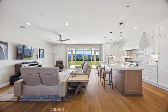 a living room with kitchen island furniture and a wooden floor