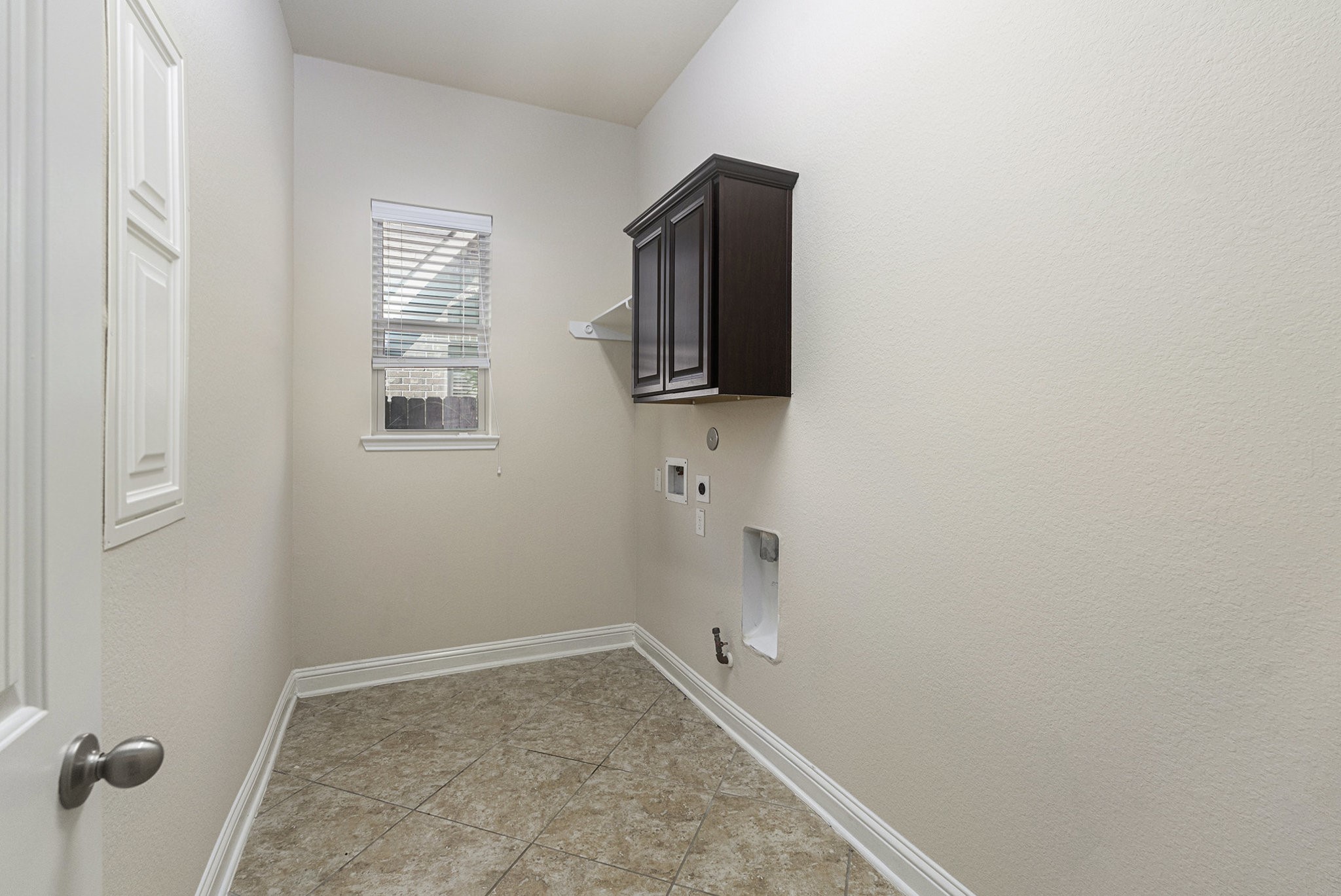 18614 Rimini Ridge Court Cypress, TX 77429 - Photo 18 of 35 a view of storage and utility room with a fireplace