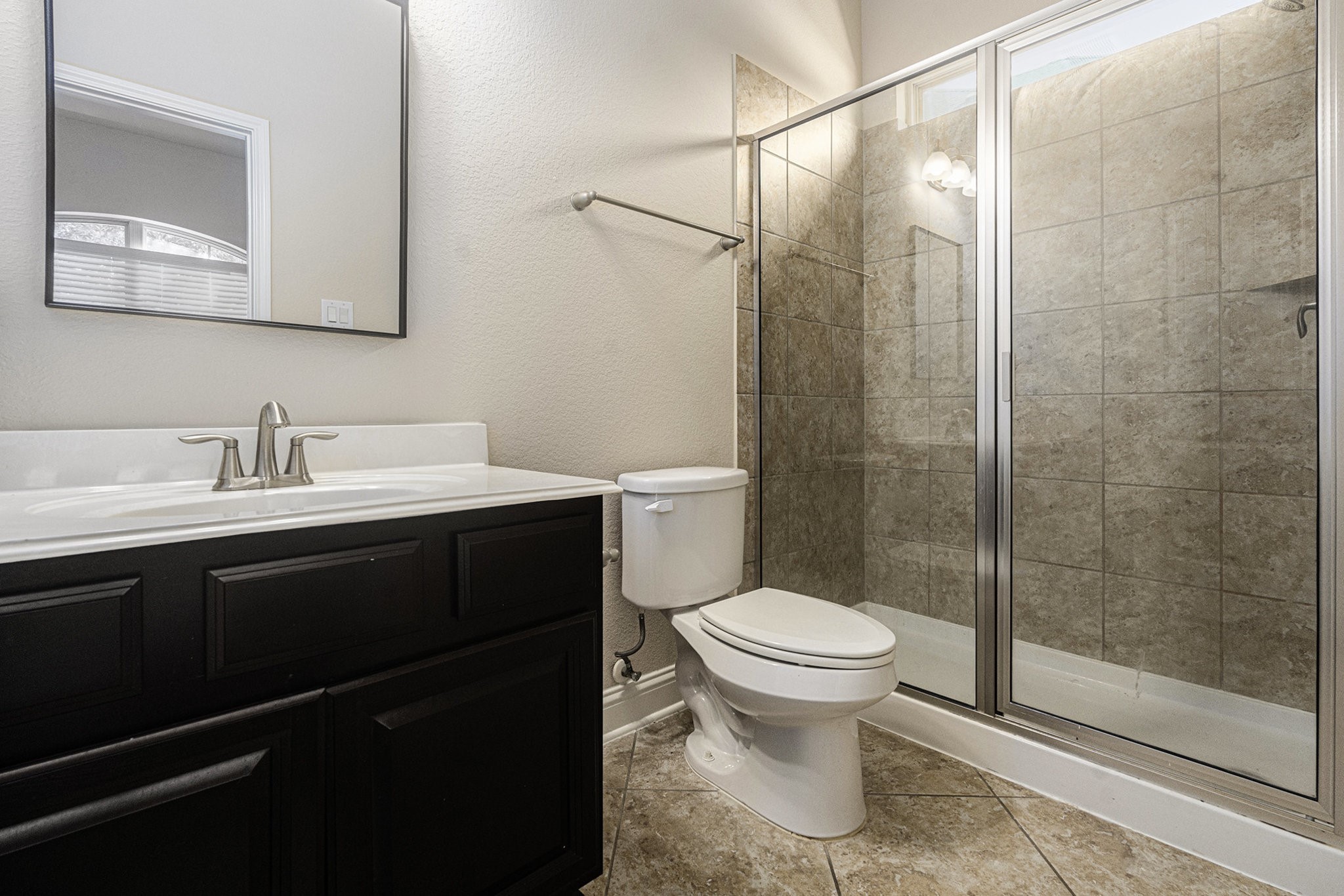 18614 Rimini Ridge Court Cypress, TX 77429 - Photo 21 of 35 a bathroom with a sink toilet and shower
