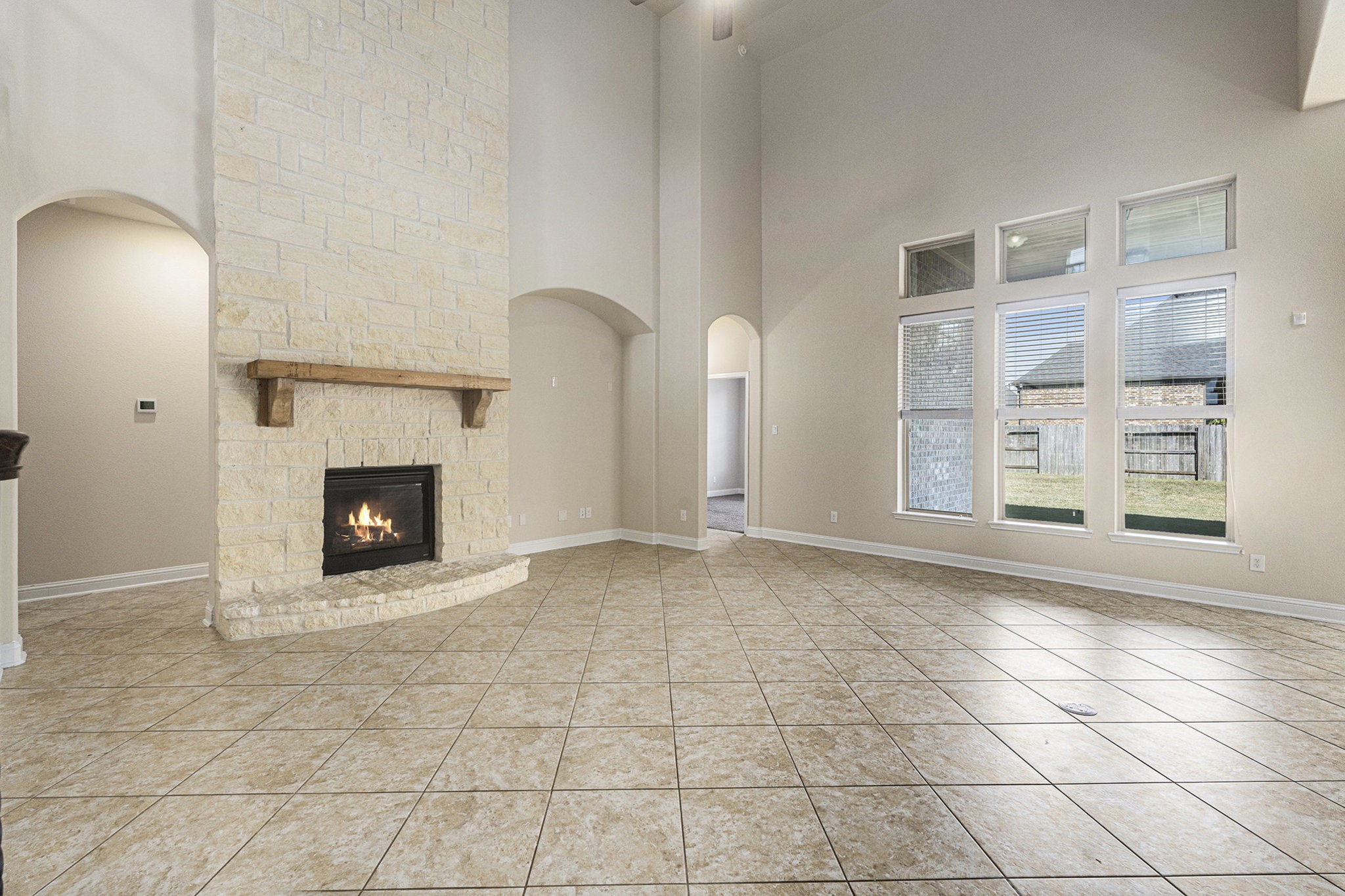 18614 Rimini Ridge Court Cypress, TX 77429 - Photo 4 of 35 a view of an empty room with a fireplace and a window