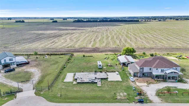 an aerial view of residential houses with outdoor space and river