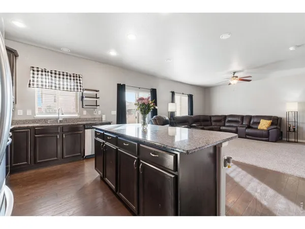 a kitchen with stainless steel appliances granite countertop a sink a stove and a refrigerator