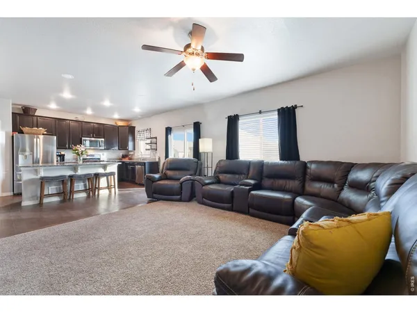 a living room with furniture and kitchen view