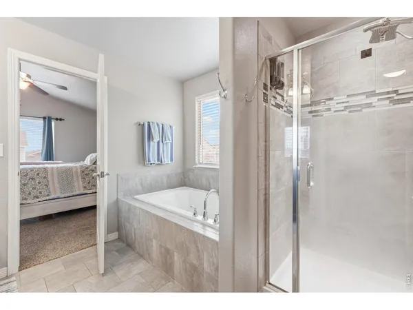 a en suite bathroom with a tub shower and sink