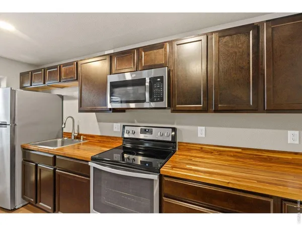 a kitchen with stainless steel appliances granite countertop a sink and a microwave