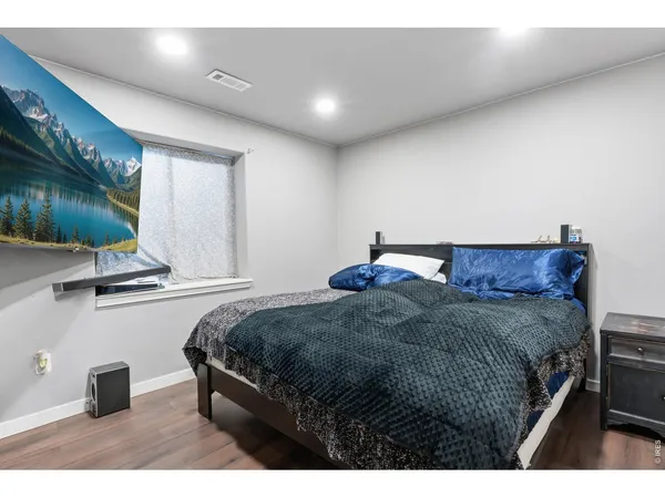 a bedroom with a bed and large mirror