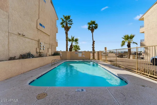 a view of a swimming pool with an outdoor seating