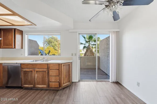 a spacious bathroom with a granite countertop sink a mirror and a shower
