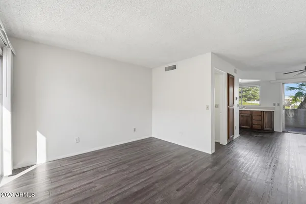 a view of a room with wooden floor and windows