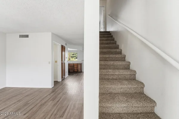 a view of a hallway with wooden floor and entryway