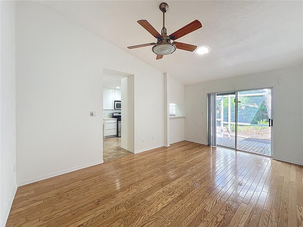 8029 Gillette Court Orlando, FL 32836 - Photo 11 of 32 a view of empty room with wooden floor and fan