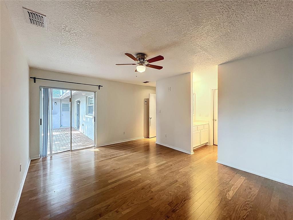 8029 Gillette Court Orlando, FL 32836 - Photo 17 of 32 an empty room with wooden floor and ceiling fan