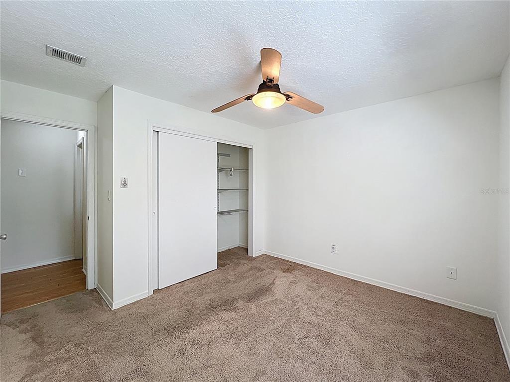 8029 Gillette Court Orlando, FL 32836 - Photo 23 of 32 an empty room with closet and a chandelier fan