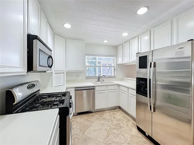 a kitchen with a sink a stove and refrigerator