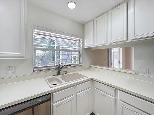a kitchen with a sink and cabinets
