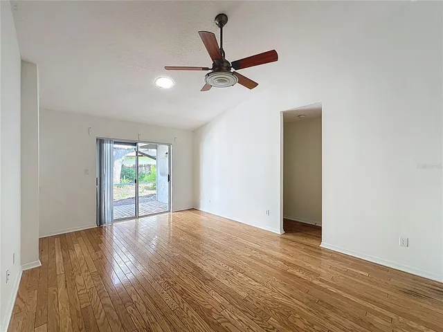 a view of empty room with wooden floor