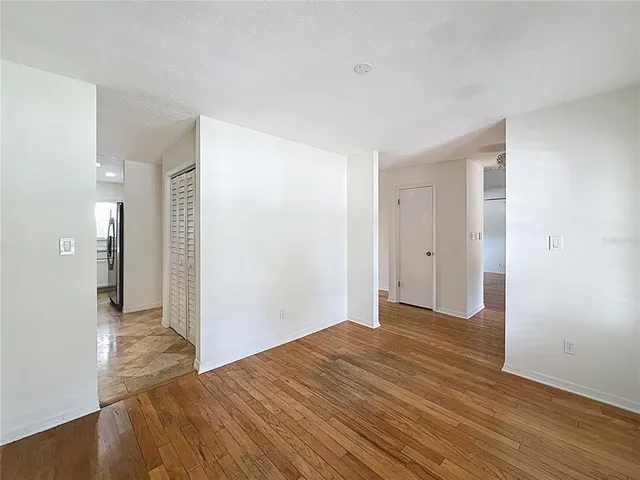 a view of hallway with wooden floor