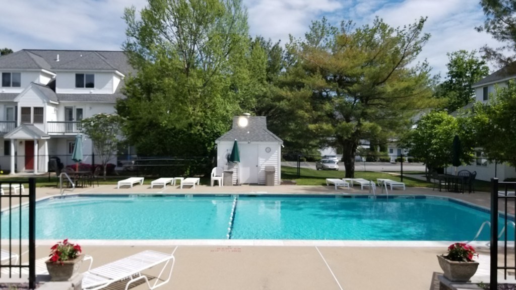 360 Littleton Road, Unit G10 Chelmsford, MA 01824 - Photo 14 of 20 a front view of a house with garden and trees