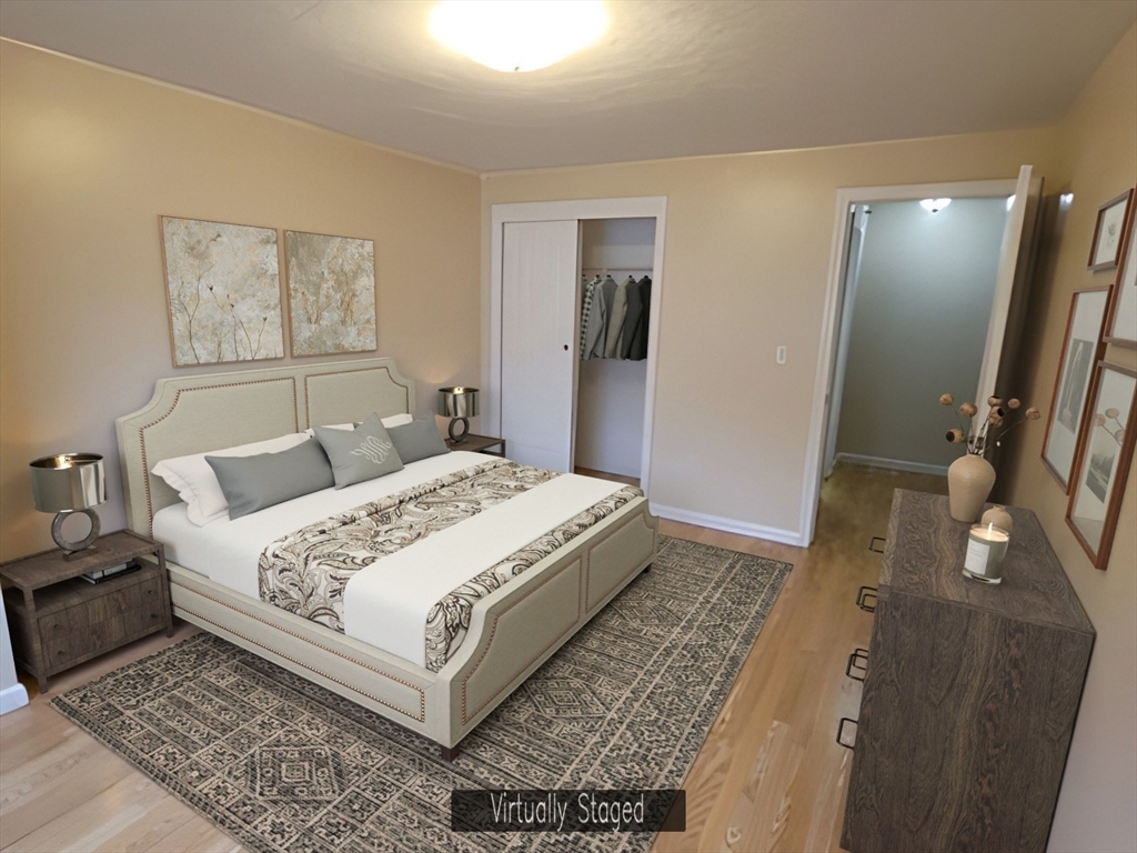 360 Littleton Road, Unit G10 Chelmsford, MA 01824 - Photo 5 of 20 a bedroom with a large bed and a mirror